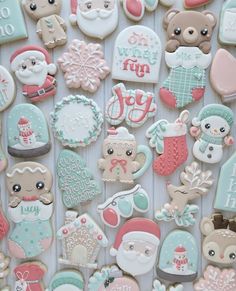 some very pretty decorated cookies on a white table with snowflakes and teddy bears