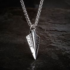 This striking Odin's Spear Necklace is perfect for those who want to make a statement. Made of solid stainless steel, this pendant is in the shape of Gungnir, Odin's spear. The runic decoration adds a touch of mystery, while the sleek, minimalist design makes it versatile enough to wear with any outfit. Supplied with matching 24" / 60cm chain Warrior Style Silver Stainless Steel Jewelry, Silver Stainless Steel Warrior Jewelry, Silver Viking Style Metal Necklace, Viking Style Engraved Metal Necklaces, Viking Style Silver Stainless Steel Jewelry, Nickel-free Viking Style Stainless Steel Jewelry, Viking Style Silver Stainless Steel Necklaces, Viking Style Stainless Steel Pendant Necklace, Viking Style Stainless Steel Silver Necklaces