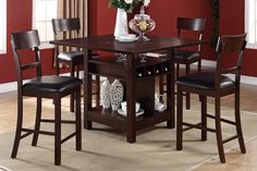 a dining room table and chairs with red walls