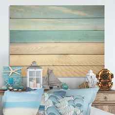 a bed with blue and white pillows next to a wooden sign on the wall above it