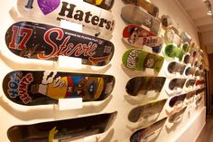 there are many skateboards mounted on the wall