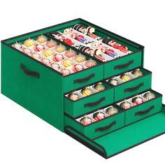 three green drawers filled with different types of items on top of each other and one is open to reveal the contents