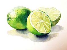 two limes with one cut in half sitting next to each other