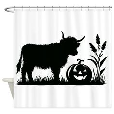 a black and white shower curtain with an image of a horned animal next to a pumpkin