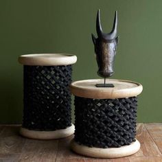 two black spools sitting on top of a wooden table