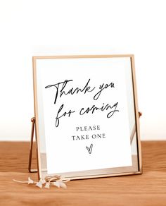 a sign that says thank you for coming and it is placed on top of a wooden table