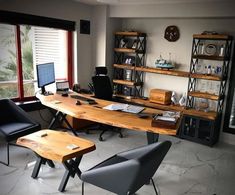 an office with two desks and chairs in front of a large window that looks out onto the outdoors