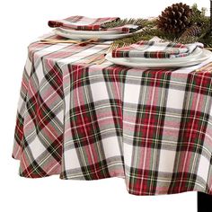 a plaid table cloth with pine cones on it