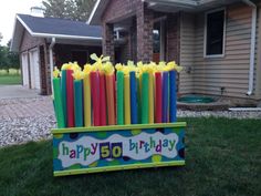 a birthday sign made out of candles in front of a house