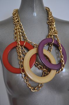 Fabulous bib necklace with huge plastic or lucite loops. Gold hardware chains and multicolor loops. Necklace closes close to the neck,strands hang down in different lengths. No damages no missing links. Not signed, statement piece. Free domestic shipping, international inquire for quote. Measures in length 18 inch, length down to the end of coins 8 inch Get 15% discount w code crazyfashion 70s Jewelry Disco, Womens 70s Fashion, 70s Accessories Jewelry, 70s Women Fashion, Chunky Jewellery, 70s Jewelry, 70s Women, Trending Necklaces, Metallic Purse