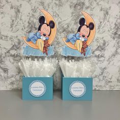 two mickey mouse cupcakes in blue boxes