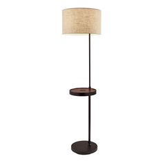 a lamp that is on top of a wooden stand with a light shade over it