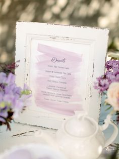 a teapot and some flowers on a table with a sign in the middle that says dinner