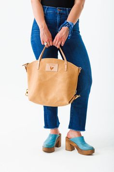 Your bag is proudly made in Lynchburg, Virginia using the finest materials in the world. H 12" (top of curve) x W 5" x 15" Top Length 4.5 ” tote handle drop Made with all natural, vegetable tanned Virginia leather* Includes removable/adjustable 1" leather backpack straps and a removable/adjustable leather crossbody strap that extends from 36" to 43" Straps are bench made with Vachetta leather** and solid brass hardware Interior hanging pocket and key clip Lined with the acclaimed Liberty of Lond Backpack With Detachable Top Handle For Everyday, Backpack With Detachable Handle For Everyday Use, Top Handle Backpack With Leather Handles, On-the-go Backpack With Leather Top Handle, Everyday Backpack With Leather Top Handle, Daily Use Backpack With Leather Top Handles, Daily Use Backpack With Top Handle And Leather Handles, Leather Saddle Bag With Leather Handles For On-the-go, Vegetable Tanned Leather Bag For On-the-go