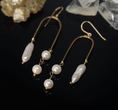 These handcrafted 14k Gold Filled Earrings are the perfect addition to any jewelry collection. Featuring an arch shape and lightweight design, these earrings will make a statement no matter the occasion. Each earring is adorned with two round freshwater pearls and one long pearl for a subtle hint of sophistication. These timeless earrings are perfect for June Birthdays and wedding jewelry. Additionally, they feature a hammered texture that is sure to capture the attention of everyone in the room Timeless Earrings, Long Pearl Earrings, Arch Earrings, Arch Shape, Pearl Jewels, Anthropologie Jewelry, Hammered Gold, Handmade Wire Jewelry, Homemade Jewelry