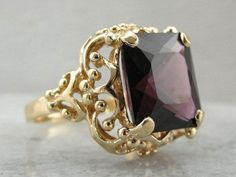 This vintage cocktail ring has lovely details that make it suitable for a spinel. The openwork basket setting lets in plenty of light, while the four sturdy prongs hold even this large stone securely. This particular stone is fantastic! The color is deep true red, with hints of raspberry, and the size is extraordinary. Spinel has a long history as a precious gem. Until modern science developed the ability to truly discern the composition of gems, spinel was considered to be red ruby, and blue sp Yellow Gold Sapphire Ring, Red Spinel, Vintage Cocktail Ring, Basket Setting, Spinel Gemstone, Large Stone, Gold Statement Ring, True Red, Solitaire Pendant