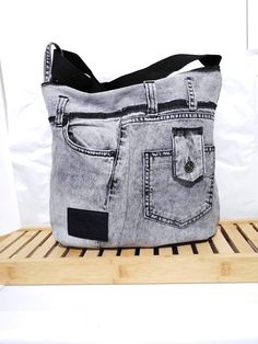 Denim Bag Black Grey Messenger Bag Crossbody Casual Bag Recycle Sholder Jeans bag Introducing our unique, handcrafted jeans bag, an ideal blend of style, functionality, and sustainability. This eye-catching denim bag is not only a great fashion statement but also a step towards conscious consumerism. Made entirely from upcycled jeans, this bag is a testament to the fact that style and eco-friendliness can go hand in hand. A great gift for you or a friend. Measures from side to side when laid flat: Width 35 cm / 14 in Lenght 35 cm/ 14 in Handle: max 110 cm / 43 in , min 60 cm / 23 in Pockets: 6 (3 inside, 3 outside - one with zipper)  Close bag with: zipper See more in my shop: https://www.etsy.com/shop/ArtAnnByBoutique?ref=profile_header Casual Denim Shoulder Bag With Flat Pocket, Black Denim Shoulder Bag For Everyday Use, Casual On-the-go Shoulder Bag With Flat Pocket, Casual Bags With Zipper Pocket In Recycled Denim, Recycled Denim Shoulder Bag With Zipper Pocket, Upcycled Recycled Denim Shoulder Bag For Everyday, Casual Upcycled Canvas Bag For Daily Use, Everyday Recycled Denim Shoulder Bag With Zipper, Recycled Denim Hobo Bag For Everyday Use