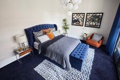 a bed room with a neatly made bed and blue carpet