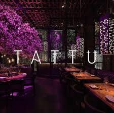 the restaurant is decorated with purple flowers and trees in full bloom, as well as its name