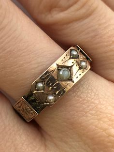 A Victorian 9ct gold pearl mourning ring. This ring is Hallmarked Chester, with the date mark of 1888. The largest pearl is set at the centre of the ring, and measures 3 x 3mm's. Set in to each corner of the central section are four round seed pearls which each measure 2 x 2mm's. The centre piece takes the form of a buckle, and around the ring there are detailed gold belt loops. Beneath the loops there is a ring of fine hair that has been very carefully and delicately platted. An excellent and meaningful example of Victorian sentiment. Finger size Q and a half. Unfortunately we are unable to re-size this ring. Unique Vintage Jewelry, Gold Edwardian Engagement Ring, Statement Gold Rings, 1800s Engagement Ring, 1920s Rings, Edwardian Rings, 1800s Jewelry, Antique Gold Ring, Victorian Jewellery