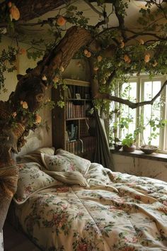 the bed is made with floral comforters and pillows in front of an open window