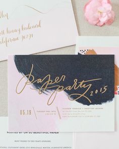 the wedding stationery is laid out on top of each other with gold calligraphy