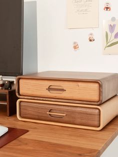 two wooden boxes sitting on top of a desk