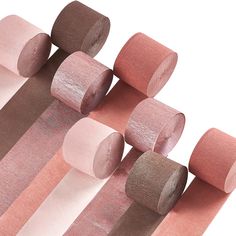 several rolls of pink, brown and white paper