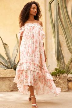 Description & Details Summer Posy Aria Chiffon Off-Shoulder Ankle Gown in Moonshine / Coral. Beautifully designed with a perfect summer print taken from a hand-painted artwork from the early 1900s. This gown is decorated with pretty posy, floral clusters scattered and dispersed throughout to create an all-over beautiful print. Developed with a romantic off-shoulder design featuring a mesh bralette for ultimate comfort and easy fit. The sleeves are voluminous and made in the softest chiffon, crea Micro Mini Dresses, Ballerina Dress, Shoulder Stretch, Short Gowns, Painted Artwork, High Low Skirt, Needle Thread, Summer Prints, Midi Length Dress