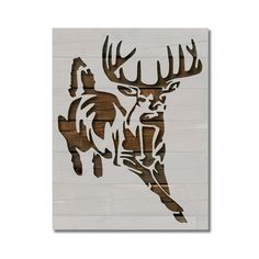 a wooden wall hanging with a deer head on it's face and antlers