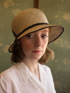 "An authentic antique woven cloche from the late 1920s or 30s era. Originally acquired by a European hat shop that closed in the 1930s. Made from a light colored woven straw with a simple yet elegant black wax coated ribbon and buckle. Only minor signs of age from storage, never been previously used. Centimeter measurements written on the inside of the crown by the hat maker. material : straw, silk? ribbon color : black, light beige condition : little to no wear, has never been used size : pleas Classic Adjustable Brimmed Cloche Hat, Gatsby Style Wide Brim Adjustable Hats, Fitted Flapper Cloche Hat With Brim, Kentucky Derby Wide Brim Flapper Hat, Adjustable Wide Brim Flapper Hat, Fitted Brimmed Gatsby Hats, Adjustable Cloche Hat In Flapper Style, Adjustable Cloche Flapper Hat, Gatsby Style Adjustable Cloche Hat With Curved Brim