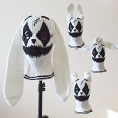 a knitted panda bear hat and scarf on a mannequin