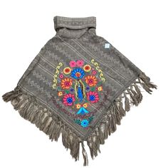 Hand Woven Fringed Poncho Featuring An Embroidered Pattern Of Our Lady Of Guadalupe With A Floral Frame. Lightweight Yet Cozy And Warm Great For Autumn And Winter Or Any Cold Day. Pair It With Jeans, Boots, Mini Skirt, Etc One Size Fits Small Up To Large Comfortably. Fall Folk Embroidered Poncho, One Size Embroidered Poncho For Festivals, Bohemian Embroidered Festival Poncho, Embroidered Poncho For Fall, One Size, Embroidered One Size Poncho For Fall, Embroidered One-size Poncho For Fall, One Size Embroidered Poncho For Fall, Winter Festival Embroidered Poncho, Festival Poncho With Multicolor Floral Embroidery