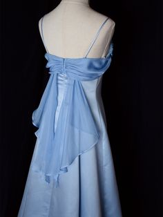 Step into timeless elegance with this Vintage Blue Satin Gown. Crafted from luxurious satin, this dress features delicate spaghetti straps that provide a graceful and feminine silhouette. The highlight of this gown is its unique winged back design, adding a touch of whimsy and sophistication. Perfect for formal occasions, evening events, or any special celebration, this elegant dress ensures you'll make a stunning entrance. The vintage blue hue adds a classic touch, making it a versatile additio Blue Satin Gown, Blue Long Prom Dresses, Hot Prom Dress, Gown Elegant, Light Blue Dresses, Prom Dress Inspiration, Long Prom Dresses, Prom Outfits, Black Prom Dresses