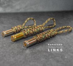 two yellow and green cords on top of a gray surface with the words paracord links written below it