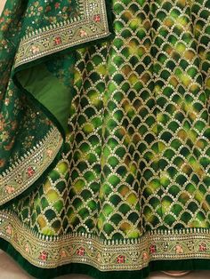 Look stunningly beautiful in this enticing green color lehenga made of art silk material embellished with thread embroidery, sequins work, dori work, and lace border work. This gorgeous green color lehenga comes with a similar color blouse designed with sequins and dori work featured with a similar color organza dupatta with floral printed and lace border work. This lovely green engagement wear lehenga is semi-stitched can fit up to 42 inches and comes with fully unstitched choli material. The l Green Color Lehenga, Sequins Lehenga Choli, Embroidery Thread Work, Sequin Lehenga, Dori Work, Designer Embroidery, Green Lehenga, Perfect Bridesmaid Dress, Color Blouse