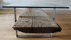 a wooden bench sitting under a glass table on top of a hard wood floor next to a white wall