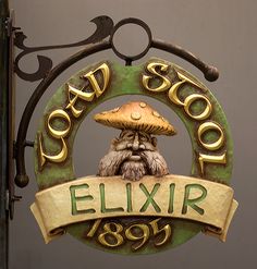 a sign that says road school elixir hanging from the side of a building