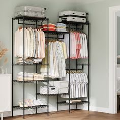 an organized closet with clothes and suitcases on it's shelves in a bedroom