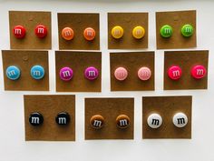 six magnets with different colored m and m on them are placed next to each other