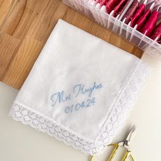 Beautiful hand embroidered, personalised handkerchiefs that can be treasured forever. These personalised hankies can are customised with your choice of wording, are perfect to gifting to your loved ones to make a truly unique gift. Add a heartfelt message or wording to make a sentimental gift. Ideal for Mother of the Bride, Mother of the Groom, Father of the Bride, Maid of Honour etc, and perfect for bridesmaid proposal boxes. Also great for a bride to be gift, to give at a hen do/bridal shower! Ideas for wording include - date, name, role in wedding, monogrammed couple initials. Embroidered by hand in high quality embroidery thread, on a lace trimmed, white handkerchief measuring 26cm x 26cm. Features Personalised with your choice of wording Can include date Personalised with your choice Embroidered White Handkerchief Gift, White Embroidered Handkerchiefs As Gift, White Handkerchiefs With Custom Embroidery For Gift, White Handkerchiefs With Custom Embroidery As Gift, Wedding Gift Handkerchiefs With Embroidered Text For Mother's Day, Personalized Cotton Handkerchiefs, White Handkerchiefs With Embroidered Text For Gift, White Handkerchiefs With Embroidered Text As Gift, Personalized Handkerchiefs For Bridesmaids, Mother's Day Gift