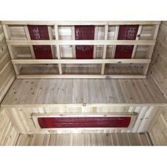 the inside of a wooden building with red shutters