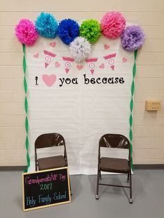 two chairs are sitting in front of a sign that says, i love you because