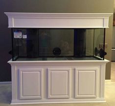 a fish tank sitting on top of a white counter