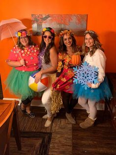 four women dressed in costumes posing for a photo