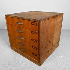 an old wooden file cabinet with five drawers