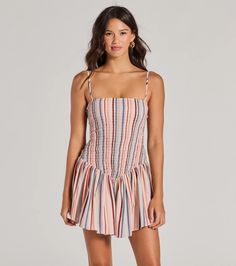 This sleeveless striped mini dress features a flattering square neckline and a smocked A-line silhouette with a trendy drop waist seam. The ruffled hem adds a flirty touch perfect for picnics or a day at the beach. Fit & FeaturesStriped woven fabricSquare necklineAdjustable spaghetti strapsSmocked A-line silhouetteDrop waist seamMini-length ruffled hemRuns true to size Trendy Mini Dress With Smocked Bodice, Trendy Striped Mini Dress For Beach, Trendy Striped Mini Dress For Summer, Trendy Sleeveless Dresses With Smocked Bodice, Striped Beach Dress With Smocked Back, Multicolor Smocked Summer Dress, Spring Striped Smocked Dress With Smocked Bodice, Summer Striped Dress With Smocked Bodice, Spring Striped Smocked Dress