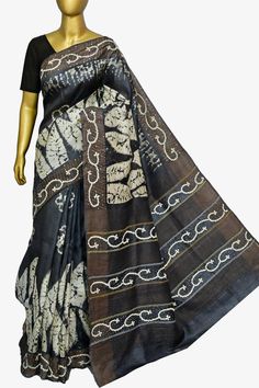 Get a new look every time with IndyVogue, like with this tussar silk with hand batik work. Available in graphite black color with amazing hand embroidery work of kantha and Gujarati stitch mixed to design a beautiful pallu and border along with hand batik work on the whole body spread unanimously. The zari work on the pallu and the border in a stacked pattern gives it a different touch. Color: A shade of graphite black color Technique: Body with hand batik work with border and pallu has Kantha & Gujarati stitch embroidery with zari work Fabric: Tussar Silk Quality: IndyVogue's Assurance of Silk Mark Certified