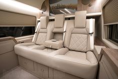 the interior of a luxury vehicle with leather seating and windows on both sides is shown