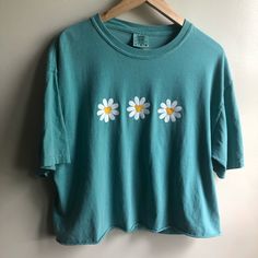 Daisy Cropped Tee Shirt. Perfect For Your Next Trip To The Theme Parks! White Daisy Flowers With Hidden Mickey Centers On A Turquoise Cropped Comfort Colors T Shirt. Never Worn. Size Large. Handmade! Purchased From Etsy Cute Short Sleeve Relaxed Fit Tops, Cute Relaxed Fit Short Sleeve Tops, Cute Green Crew Neck Top, Cute Daisy Print Summer Tops, Cute Crew Neck Tops For Spring, Cute Screen Print Tops For Spring, Cute Spring Tops With Screen Print, Cute Tops With Screen Print For Spring, Cotton Daisy Print Tops For Summer